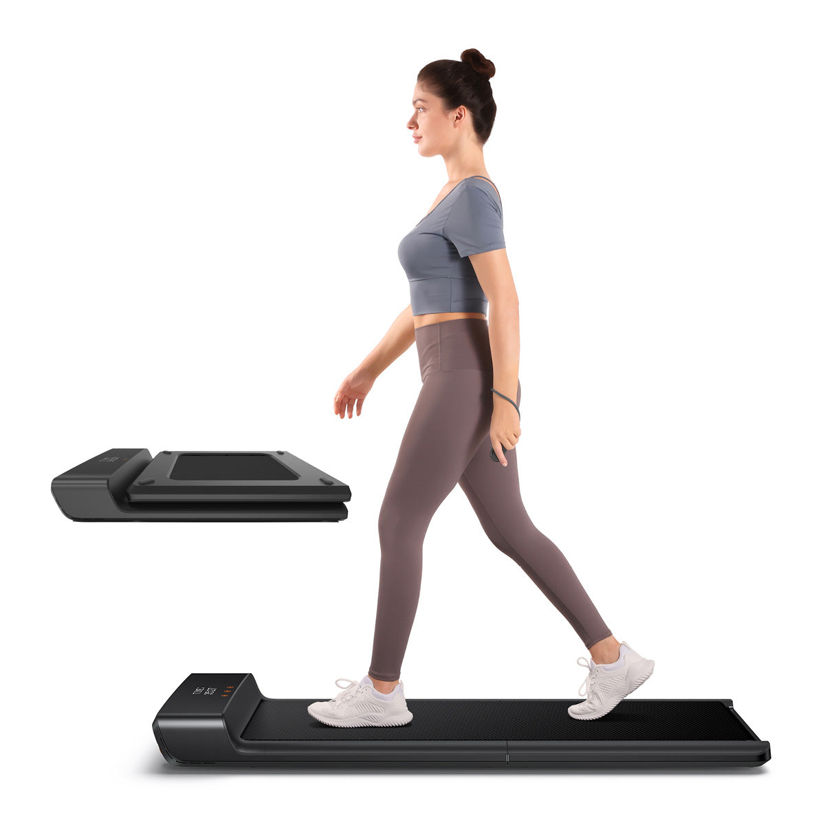 Eine Frau geht auf einem kompakten, faltbaren Laufband; der Kingsmith WalkingPad A1 Pro Klappbares Laufband Schreibtisch bis 136 kg ist vor einem weißen Hintergrund neben ihr gefaltet dargestellt.